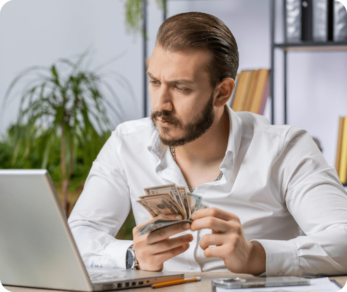 Man counting money thinking about staff costs