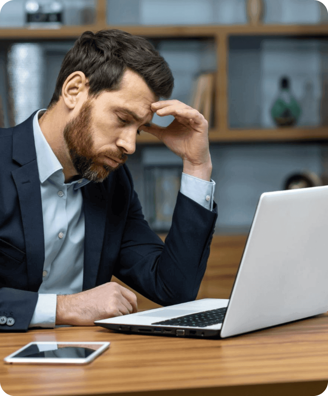 Business owner reviewing outsourcing plans at a laptop
